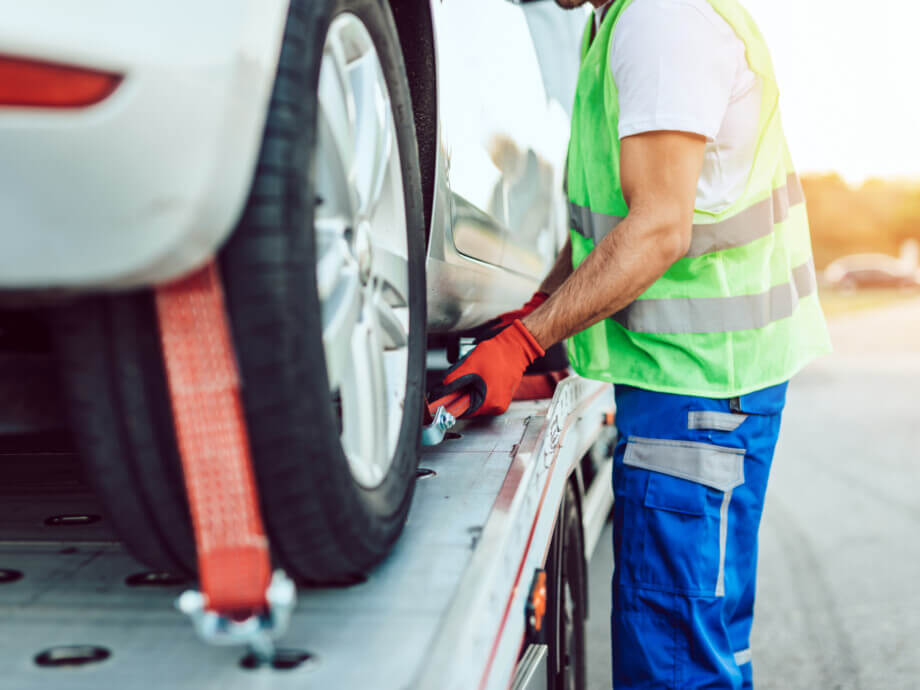 Handsome middle age man working in towing service on the road.